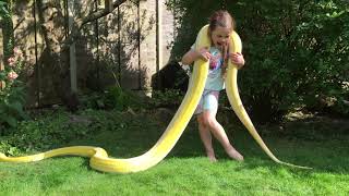5 year old outside in the coils of a Reticulated Python
