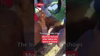 Clumsy Mourner Falls Into Grave