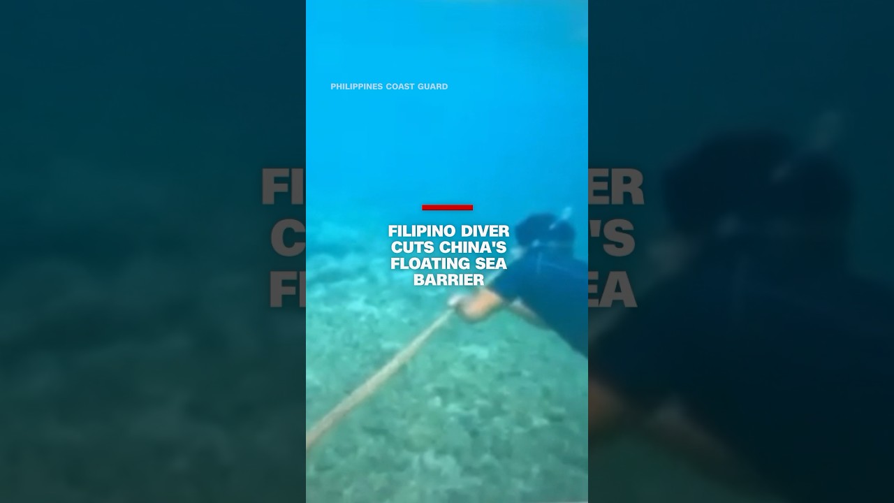 Filipino diver cuts China’s floating barrier