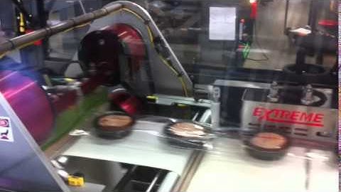Automatic shrink wrap machine in bakery application with seal strip tape