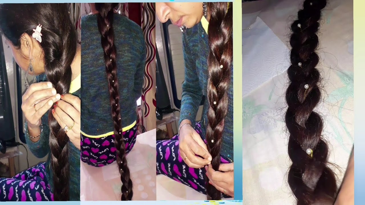 Длинная коса украшена жемчугом.