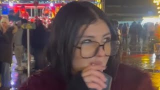 A Beautiful Girl Smokes At A Fair And Litters On The Floor.