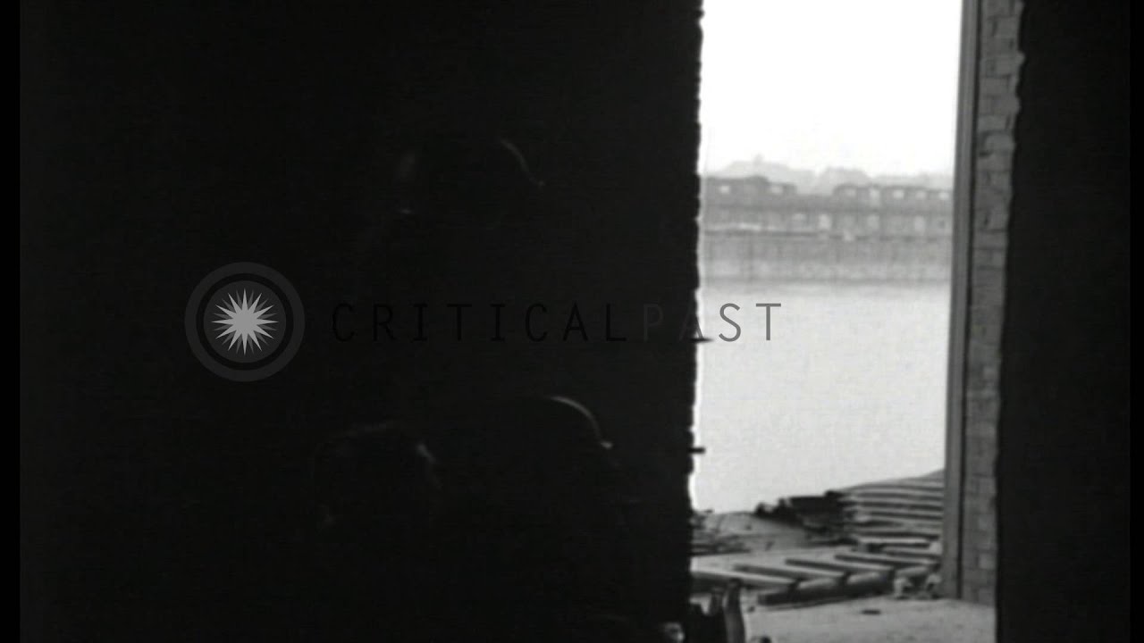 Patrol of U.S. 71st Infantry Division advances cautiously through ruins of Ludwig...HD Stock Footage