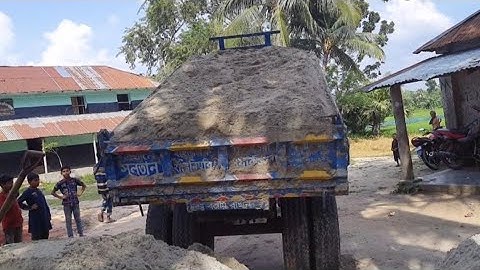 Sand is load from the river into tractor and unload over rough road through hydraulic facilities 2