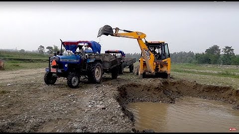 JCB 3DX Machine Working In River Side / JCB Dozer Loading A Mix Ballast In Tractor
