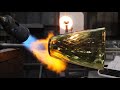 Narrated glassblowing process, pulling cane and creating a vase
