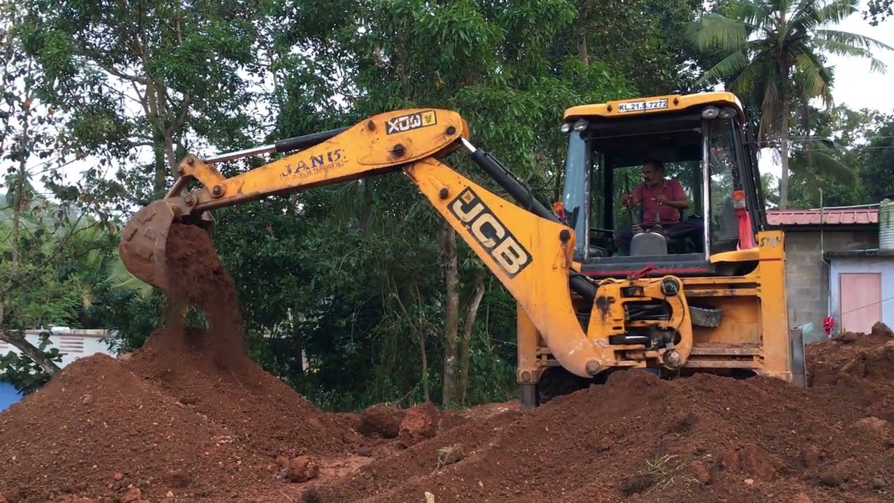 Jcb 3dx digging and moving soil for levelling land