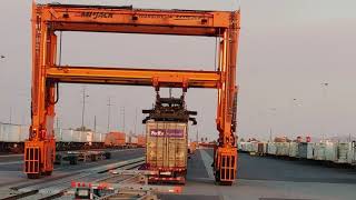 Railyard machinery lifts shipping containers on and off trains.