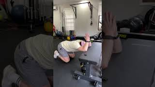 kneeling lat stretch on the bench