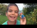 Child plays with toys and received new gift cars, ball and colored blocks.