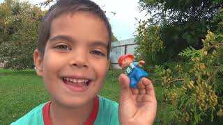 Child plays with toys and received new gift cars, ball and colored blocks.