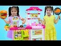 Suri and annie cooking pretend food with toy kitchen play set