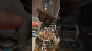 Ancient Metaler makes coffee using a syphon coffee maker