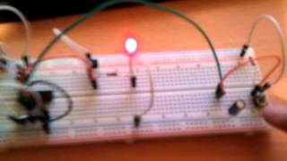 Toggle button with capacitor for debouncing