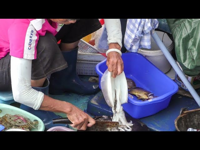 Cutting Cuttlefish, Squid and More Fish at Sai Kung Seafood Boat Market. Hong Kong