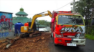 Mini Excavator CAT Loading Dead Trees Into Truck