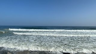 A Nice View of Hampton Beach with good waves and guys surfing