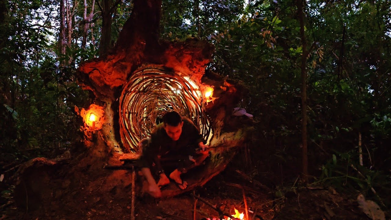 Create shelter in the base of a large tree, grill the large snake for overnight food.wild place