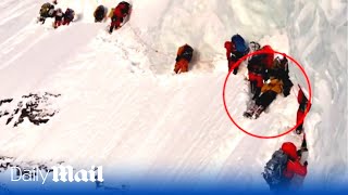 Tragic moment climbers pass a dying Pakistani porter on K2 - the world's second highest mountain Resimi