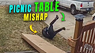 Man Falls While Moving a Picnic Table