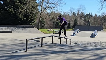 Board slide up skate park rail