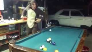 A Monkey playing pool.