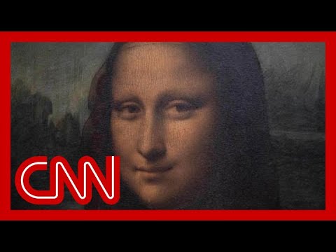 Man in disguise throws a cake at the 'Mona Lisa'