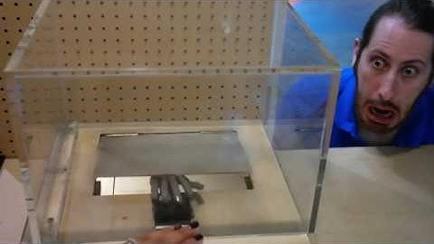 Robotic hand peeking through a trapdoor