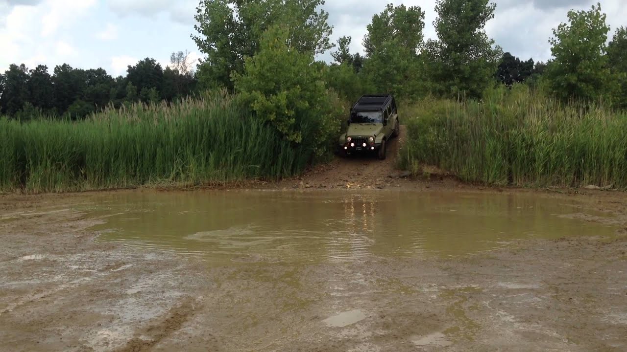 2013 Jeep Wrangler JK Sahara, going through a deep mud puddle