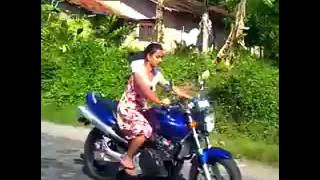 Sri lankan Girl ride hornet motorbike in road