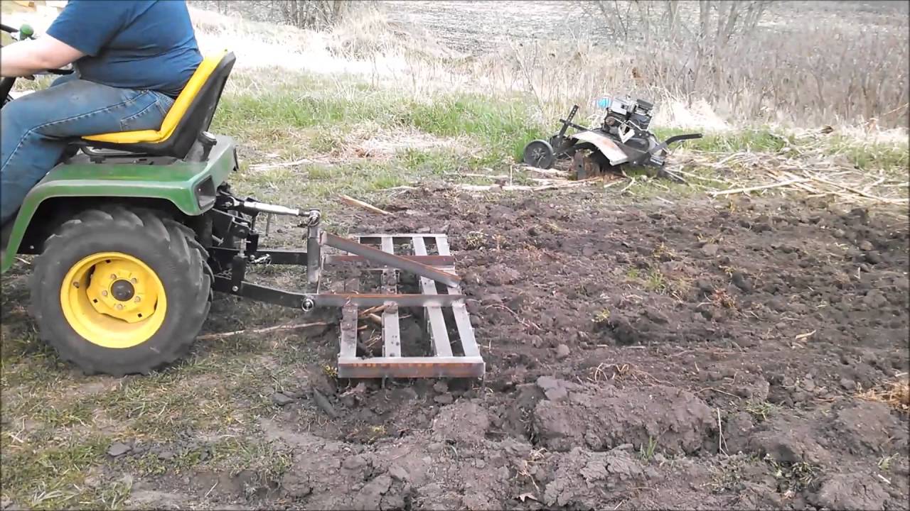 John Deere 316 pulling $25 DIY Cat 0 spike harrow - YouTube