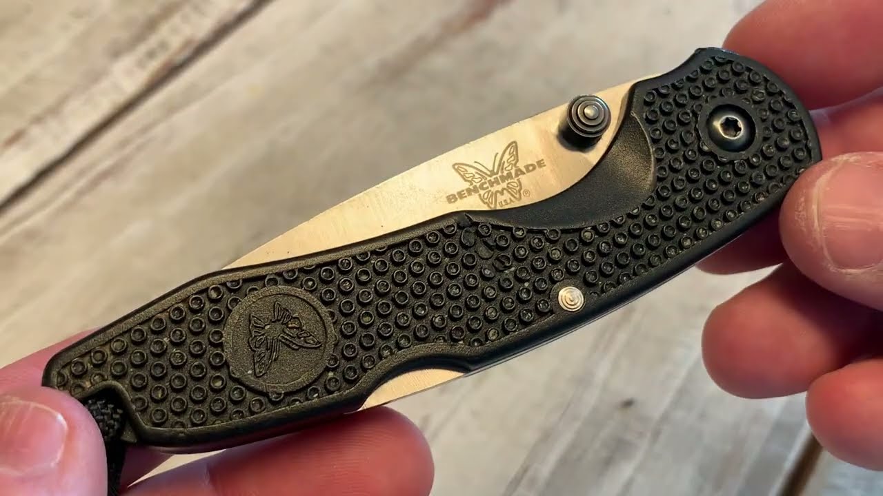 Vintage Benchmade USA ATS-34 lock-blade tactical pocket knife with half serrated blade