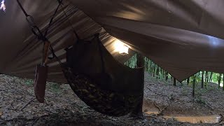 Tying a hammock to sleep in a rubber plantation on a heavy rain night