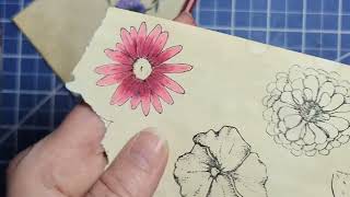 Coloring stamped flowers with Prismacolors.