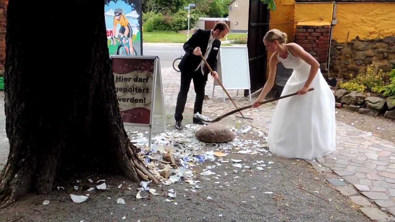 German couple cleaning porcelain plates thrown by the guests