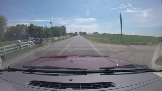 crop duster low pass over road