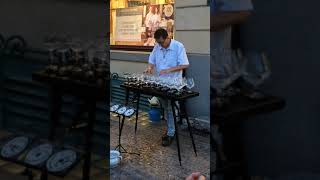Man playing music with glasses filled with water