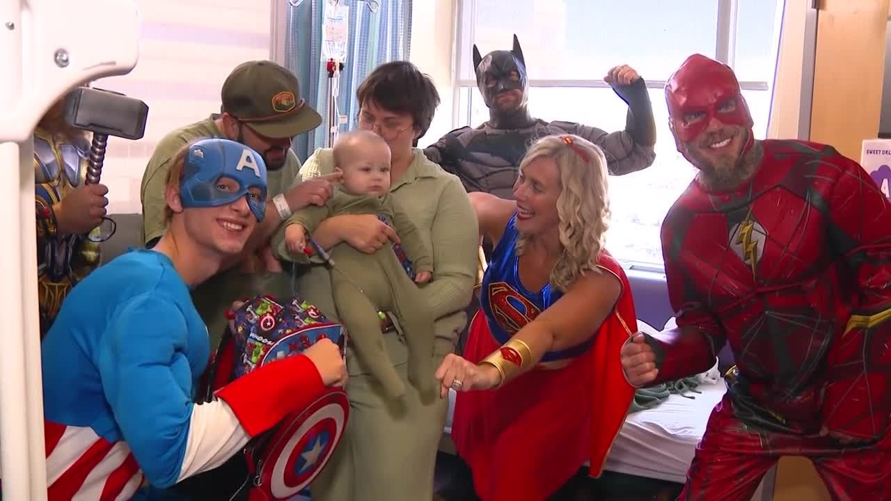 'They're the real heroes': Window-washing superheroes bring smiles to young patients' faces