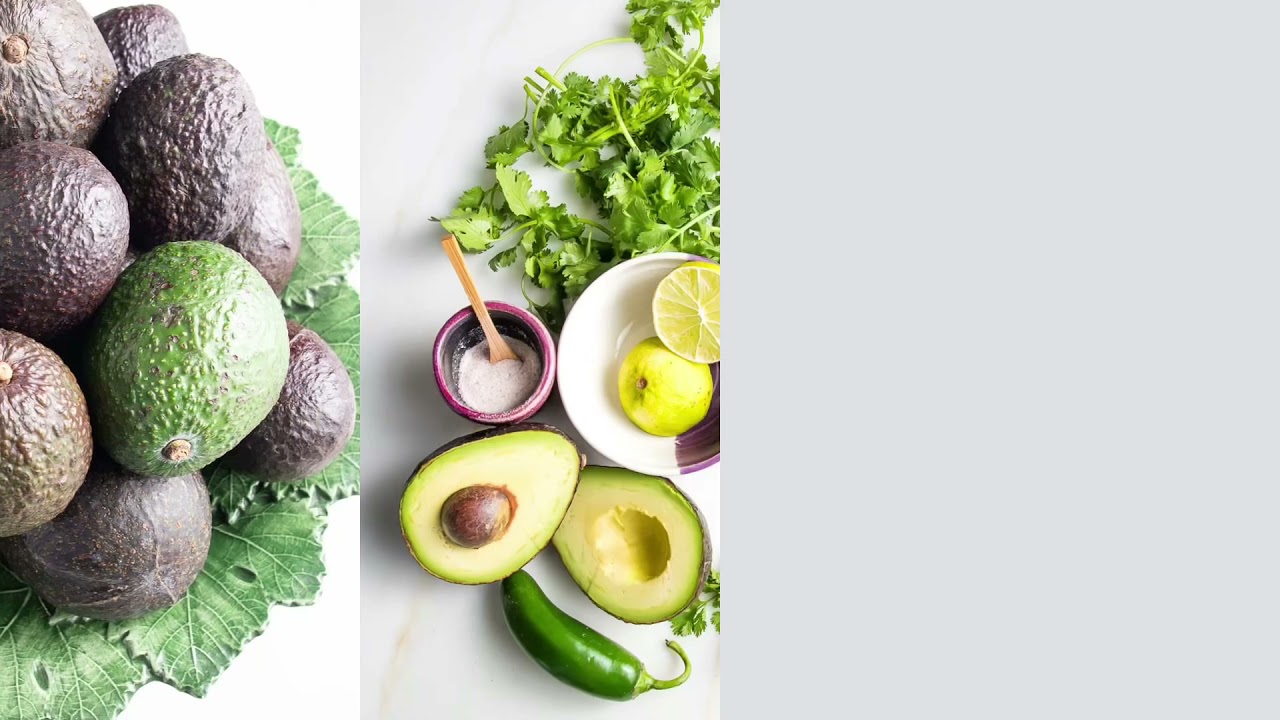 Premium Photo  Avocado cut in half on a wooden table, coriander and basil  next to a straw bag. concept of proper and healthy nutrition, vegetarianism.