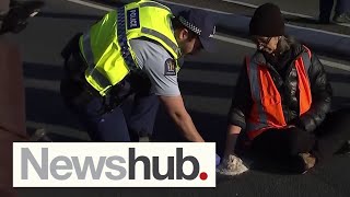 Climate protester causes commuter chaos by concreting hand to Wellington road  | Newshub