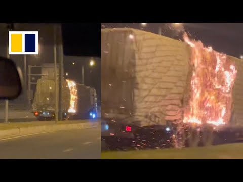 Motorist chases after burning truck to stop driver