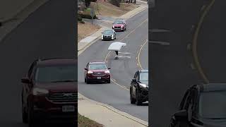 Skateboarder Rides Street Holding Big Mattress