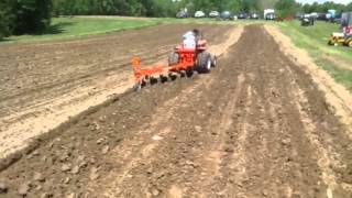 miniature tractor plowing the land