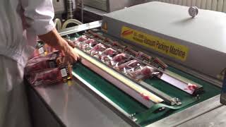 Continuous belt type vacuum packaging machine