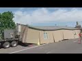 Double wide falls off truck trailer