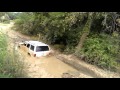 Chevrolet suburban pulling out a jeep from mud pit