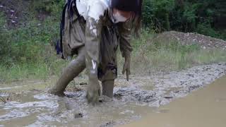 The girl accidentally slipped and fell into the mud