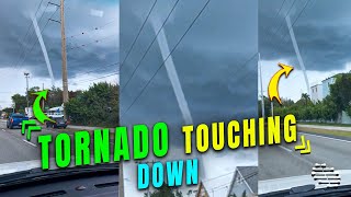 Tornado Touching Down Filmed from a Car Moving on the Road