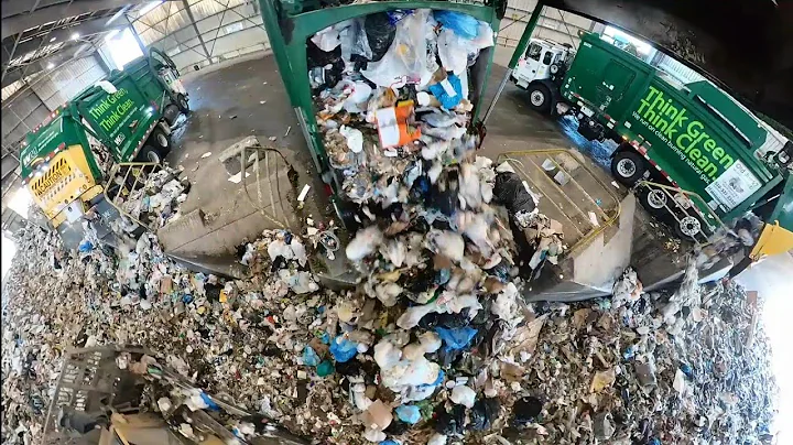 Garbage trucks dumping at transfer station.