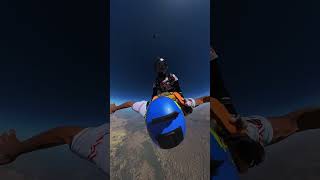 Skydiver Hitchhiking Another’s Back As They Descend Together